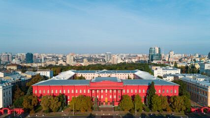 Aerial view building Kyiv National University of Taras Shevchenko on a sunny spring day. Drone shot red building facade. Capital of Ukraine - obrazy, fototapety, plakaty