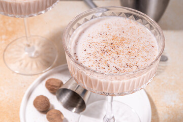 Boozy creamy Brandy Alexander Cocktail with nutmeg. Trendy autumn winter alcohol drink 