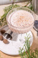 Boozy creamy Brandy Alexander Cocktail with nutmeg. Trendy autumn winter alcohol drink 