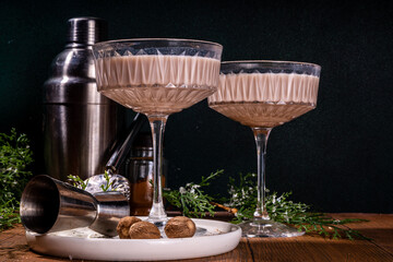 Boozy creamy Brandy Alexander Cocktail with nutmeg. Trendy autumn winter alcohol drink 