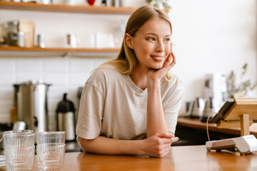 Young beautiful attractive long-haired smiling woman propping her head © Drobot Dean