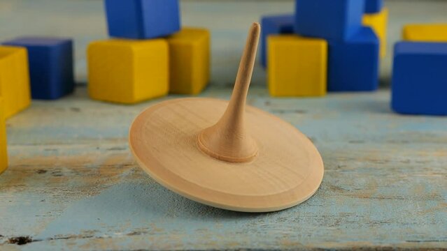 Peg toy or whirligig rotates on a vintage wooden board