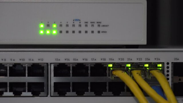 Close-up of network switches with connection status lights. High-speed communication is modern.