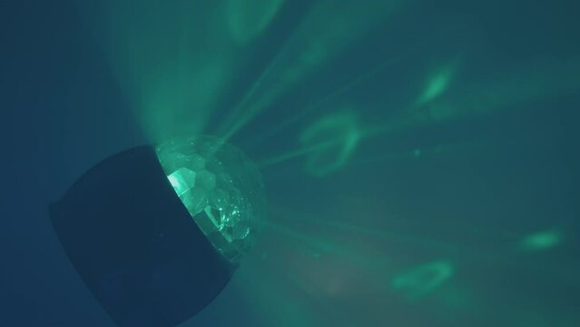 Color, RGB ball of color music shines with laser beams in the disco smoke. Concept of abstract background, dance floor, music and entertainment