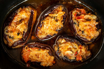 Imam bayildi – Turkish stuffed aubergines homemade dish. Close-up view.