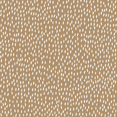 white drops pattern on the beige background