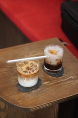 Closeup of Iced Caramel Macchiato at the coffee shop, Caramel Macchiato is a classic macchiato beverage. It consists of vanilla syrup, espresso, steamed milk, foam, and caramel drizzle