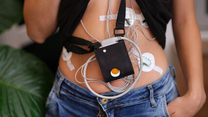24-hour ECG monitoring and Holter monitoring on a woman body