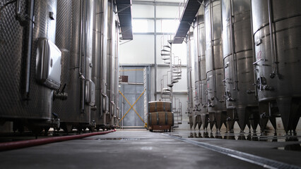 Modern winery interior with large metal tanks