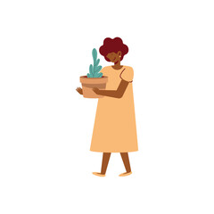 afro woman lifting houseplant