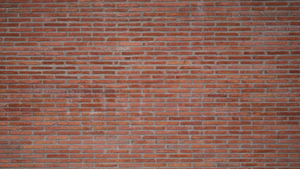 Texture of the wall of thin long red bricks