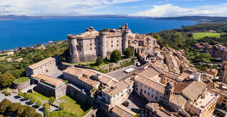 Medieval castles of Italy - Castello Orsini-Odescalchi in Bracciano town and lake. Aerial drone view. Lazio region - obrazy, fototapety, plakaty