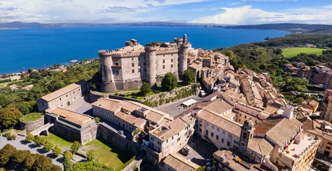 Schilderijen op glas Medieval castles of Italy - Castello Orsini-Odescalchi in Bracciano town and lake. Aerial drone view. Lazio region © Freesurf