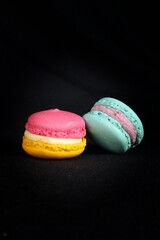 colorful macaroons on black background
