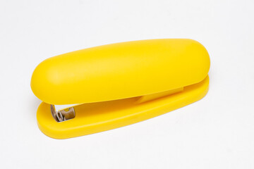 Yellow stationery paper stapler isolated on white background - obrazy, fototapety, plakaty