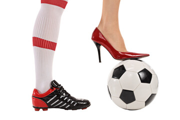 Soccer shoe and high-heeled shoe pressing a football