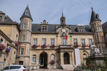 Fototapeta na wymiar Famous historical Melun Town Hall (Hotel de Ville, 1846 - 1848). Town Hall combining neoclassical and neo-Renaissance styles, decorated with flags and flowers. Melun, France. 