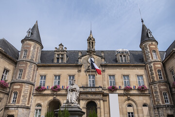 Famous historical Melun Town Hall (Hotel de Ville, 1846 - 1848). Town Hall combining neoclassical and neo-Renaissance styles, decorated with flags and flowers. Melun, France.  - obrazy, fototapety, plakaty