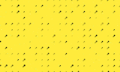 Seamless background pattern of evenly spaced black baby rattle symbols of different sizes and opacity. Vector illustration on yellow background with stars