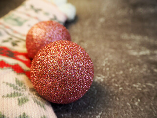 two round red Christmas toys.  lie on a gray background.  Christmas