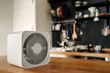 autumn concept and technology. air heater in the apartment against the backdrop of a cozy interior.
