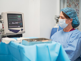 Doctor checking vital signs monitor