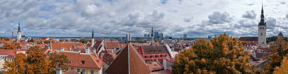 Bird view of historic city center of Tallinn, Estonia and modern town behind. Autumn trees, towers...