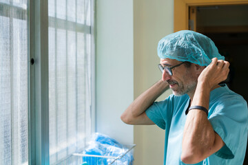 Surgeon putting on cap