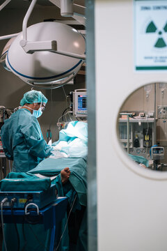 Surgeon standing near patient