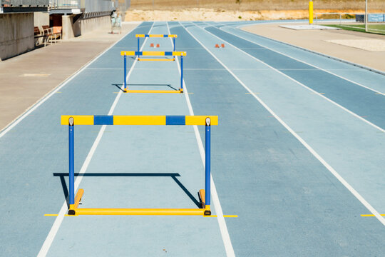 Colorful hurdles on blue racetrack