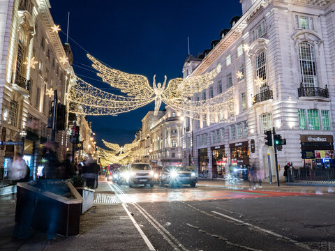 Regent Street Christmas lights, London. The seasonal illuminations at dusk in central London during the holiday season.