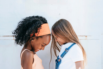 Cheerful African American girl with best friend having fun near