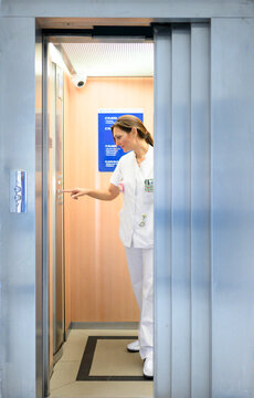 Female doctor using elevator in hospital