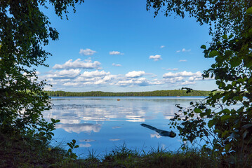 Fototapeta na wymiar Clouds are reflected in the water surface . The Lake Is Large . Vsevolozhsk. Leningrad region.