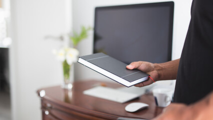 man looking at his work schedule in front of computer