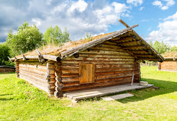 Obraz premium Ancient wooden residential house in Russia. X century settlement, typical houses reconstruction