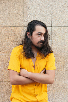 Portrait os stylish man with long hair in city