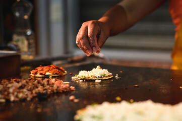 Crop cook preparing tasty tacos in restaurant kitchen