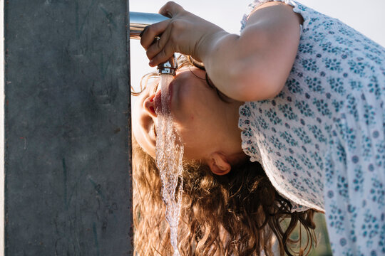 Girl Drinking Water From Standpipe