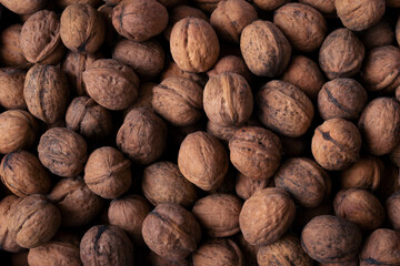 Background of walnuts close up. A full source of vegetable protein in the vegetarianism and raw food. Concept - healthy eating.