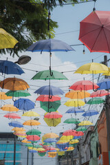 Fototapeta na wymiar Pereira, Risaralda, Colombia. February 3, 2022: The famous meeting street in the city decorated with colored umbrellas.
