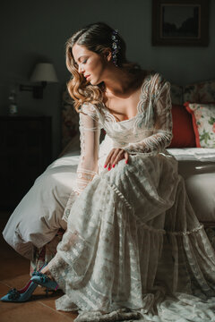 Attractive woman in dress putting on shoes