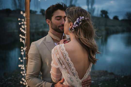 Man in suit kissing bride