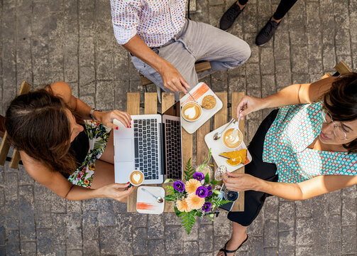 People having breakfast using laptop