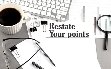 RESTATE YOUR POINTS text on a paper with magnifier, coffee and keyboard on grey background
