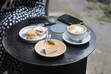 A cup of latte art and bakery on the table