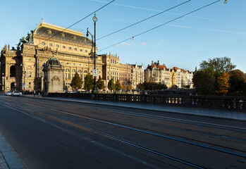 Selective focus with Legions bridge across the Vltava river to the National Theater in Prague at sunset