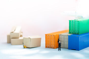 Miniature people: Businessman on container airplane with copy space for text using as background...