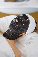 Woman with alginate mask on face in beauty salon