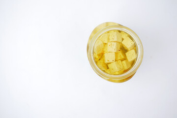 cheese cube , olive and herbs in a container on table 